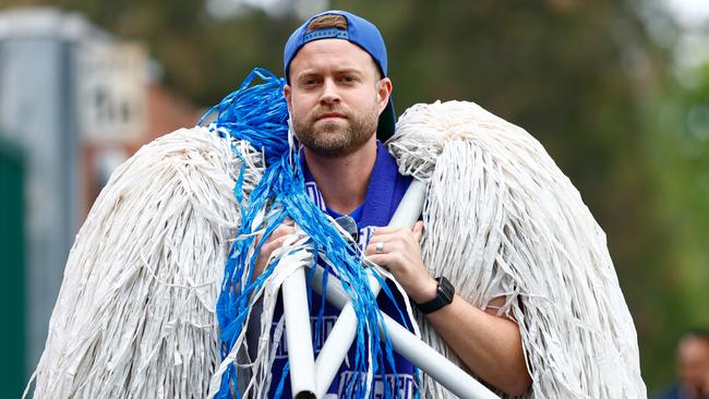 A member of the North Melbourne cheer squad arrives. Picture: Getty Images