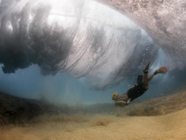 Photo by Matt Porteous / National Geographic Nature Photographer of the Year contest. Ocean Power when a wave breaks in front of you out in the ocean, you still have time to break through. Capturing my friend and Film maker Googsi as he creeps below a breaking wave.