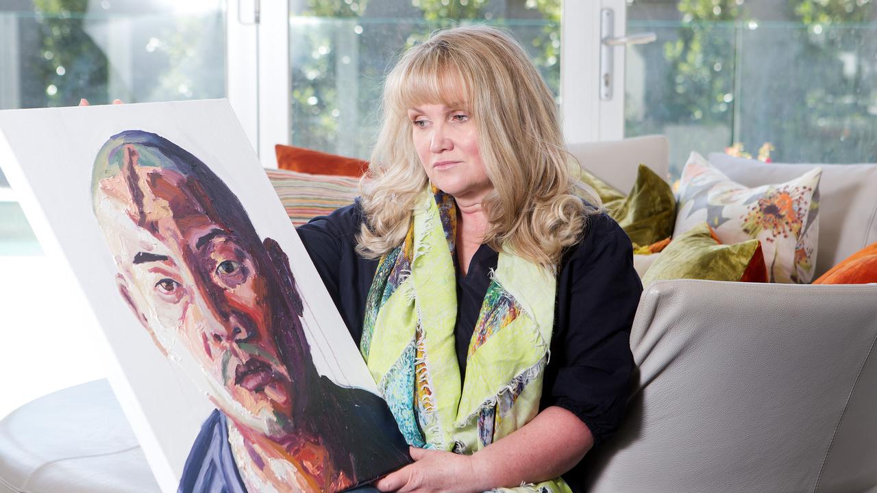 Christie Buckingham pictured with an original portrait of Andrew Chan painted by Myuran Sukamaran. Picture: Sarah Matray