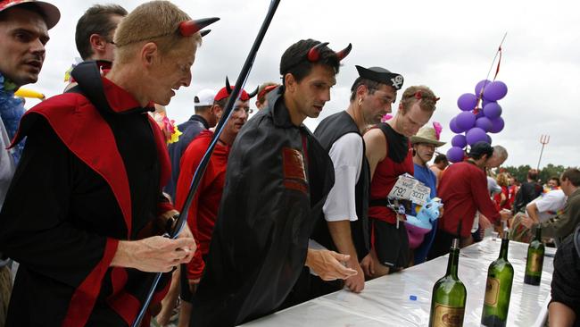 Runners enjoy wine at a chateau during a food and wine break in the Marathon du Medoc race. Picture: Denis Doyle/Getty Images