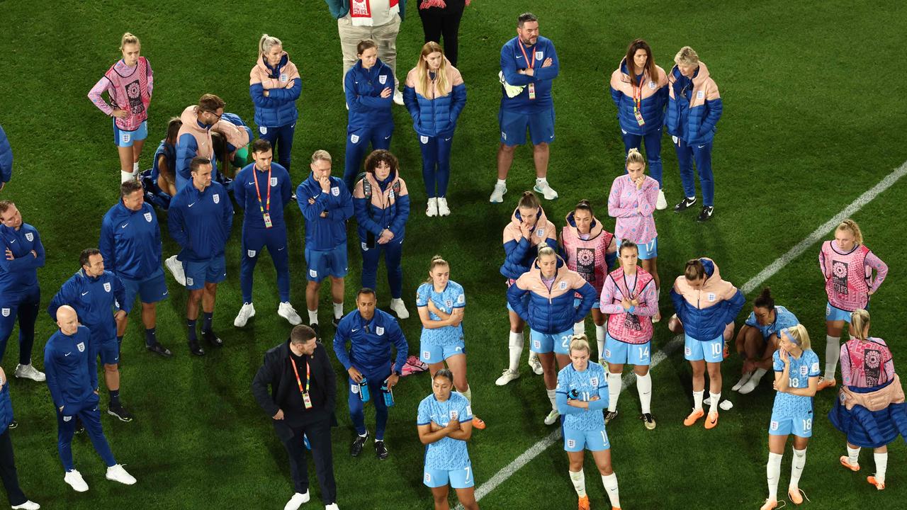 England’s forlorn players and coaching staff look on. Picture: David Gray/AFP