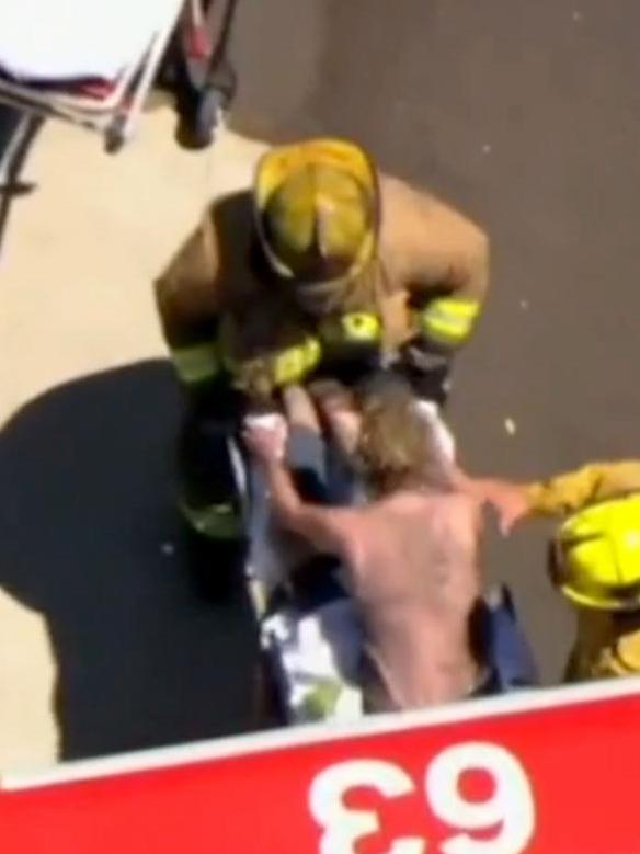 Stills from Fox11 see Heche's burned back as she's put on a stretcher.