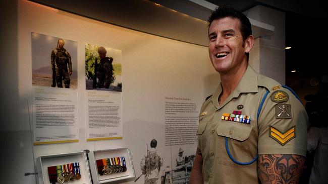 Ben Roberts-Smith checks out his Victoria Cross, Medal for Gallantry and other medals now on display in the Hall of Valour at the Australian War Memorial.