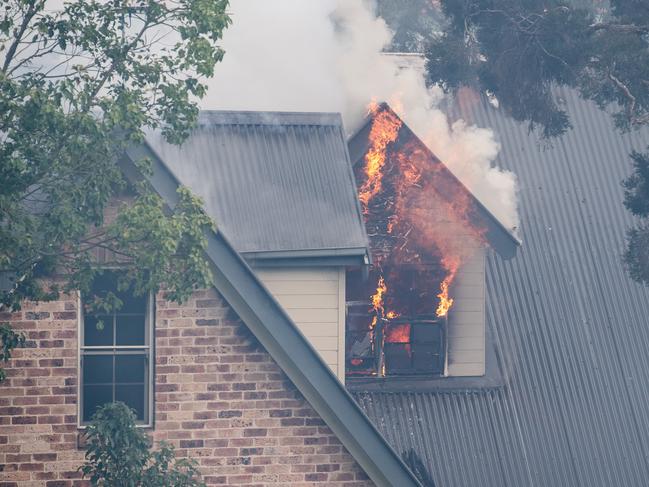 SYDNEY, AUSTRALIA - NewsWire Photos November 29, 2020: A house on fire on Whitehaven Road, Northmead, Sydney. A bushfire started nearby and spread to the house, with Fire and RFS crews on scene to try and control the bushfire and the house fire. Picture: NCA NewsWire / James Gourley