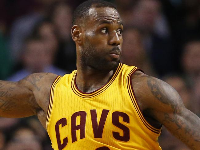 Cleveland Cavaliers forward LeBron James holds the ball away from Boston Celtics guard Isaiah Thomas during the second quarter of a NBA basketball game in Boston Tuesday, Dec. 15, 2015. (AP Photo/Winslow Townson)