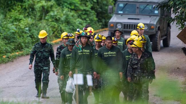 Thai soldiers walk out from the Tham Luang cave area as operations continue for the 8 boys and their coach trapped at the cave in Khun Nam Nang Non Forest Park in the Mae Sai district of Chiang Rai province on July 9, 2018. Four boys among the group of 13 trapped in a flooded Thai cave for more than a fortnight were rescued on July 8 after surviving a treacherous escape, raising hopes elite divers would also save the others soon. / AFP PHOTO / YE AUNG THU