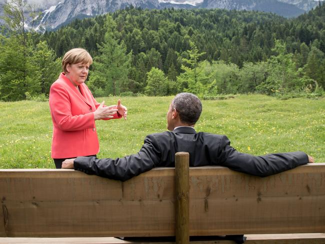Germany’s Chancellor Angela Merkel (L) gestures while chatting with US President Barack Obama sitting on a bench outside the Elmau Castle on June 8, 2015. Picture: AFP PHOTO / MICHAEL KAPPELER