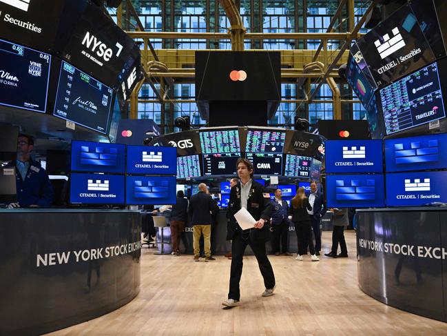 (FILES) In this file photo taken on November 13, 2024, traders work on the floor of the New York Stock Exchange (NYSE) at the opening bell in New York City. Wall Street stocks opened higher Monday as investors reacted positively to Donald Trump's Treasury Department pick at the start of a holiday-shortened week that will include economic data and earnings reports. (Photo by ANGELA WEISS / AFP)