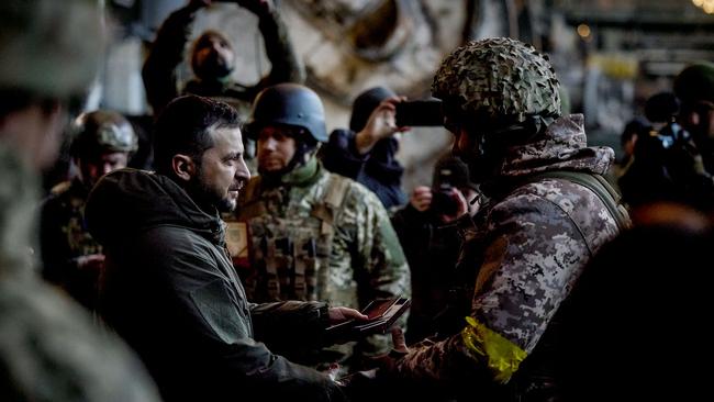 Ukraine President Volodymyr Zelensky hands out the State Award to a soldier during a medal giving ceremony to Ukrainian servicemen who have been holding back a fierce and months-long Russian military campaign for the eastern frontline city of Bakhmut.