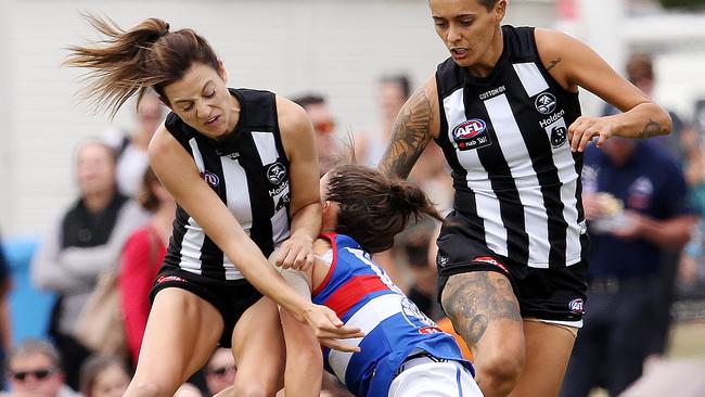 Collingwood's Steph Chiocci cleans up Libby Birch. Picture: Michael Klein