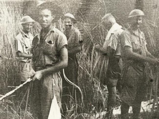 Smiles despite the fear … one of the photos that, against all odds, documented the Australians’ time stranded behind Japanese lines. Here they are trying to build a raft from reeds. Picture courtesy of Tom Trumble.