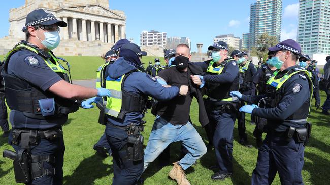 A protester clashes with officers at the Shrine of Remembrance. Picture: Alex Coppel