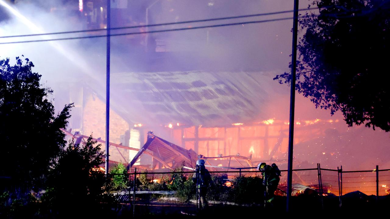 Multiple fire units spray water on buildings on fire in Hubert St, Gabba. Photo Steve Pohlner