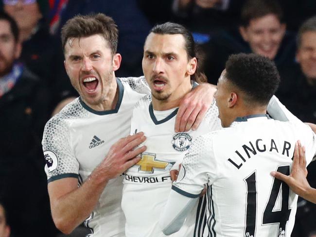 Manchester United's Swedish striker Zlatan Ibrahimovic (2L) celebrates scoring their second goal with Manchester United's English midfielder Michael Carrick (L) and Manchester United's English midfielder Jesse Lingard (R) during the English Premier League football match between Crystal Palace and Manchester United at Selhurst Park in south London on December 14, 2016. / AFP PHOTO / Adrian DENNIS / RESTRICTED TO EDITORIAL USE. No use with unauthorized audio, video, data, fixture lists, club/league logos or 'live' services. Online in-match use limited to 75 images, no video emulation. No use in betting, games or single club/league/player publications. /