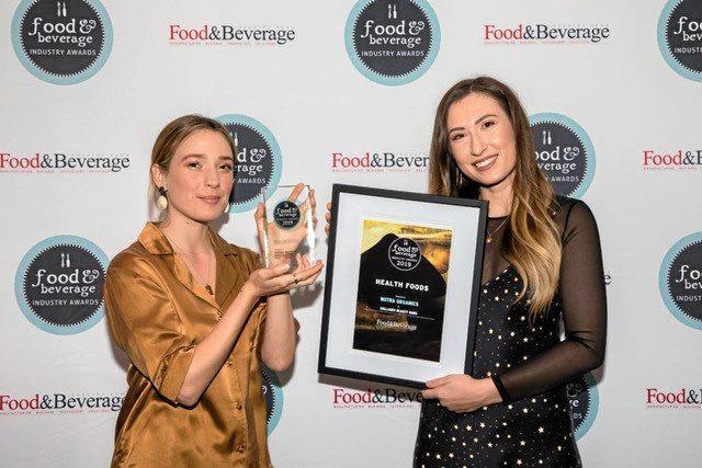 Nutra Organics Naturopath Eliza Mätas and Marketing Manager Jemma Quinlan accept the Health Food of the Year award.