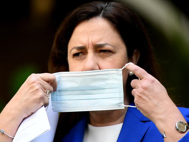 BRISBANE, AUSTRALIA - NewsWire Photos - MARCH 31, 2021.Queensland Premier Annastacia Palaszczuk puts on a face mask during a press conference to provide a Covid update at Parliament House. Brisbane has been placed in a  3-day lockdown due to a growing covid cluster.Picture: NCA NewsWire / Dan Peled