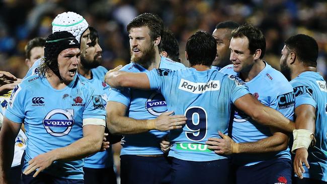 Waratahs players celebrate their fourth straight victory over the Brumbies.