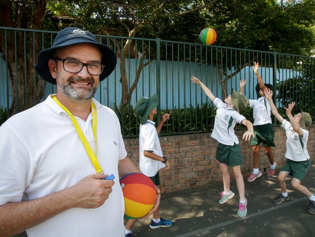 Gordon East Public School Assistant Principal, Simon Hutchison, leads play time with students, from left, Rohan Parikh, 12, Isabel Bown, 10, Asha Parikh, 10, and Fred Bown, 12. Picture: Liam Driver