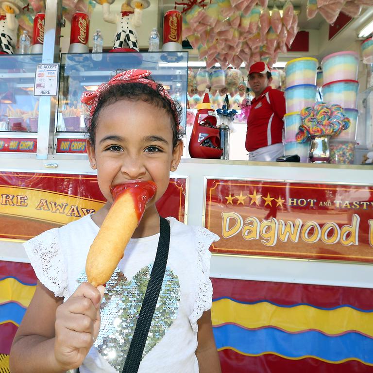 Sovaia Nullmeyer enjoying her first ever dagwood dog. Picture: Richard Gosling