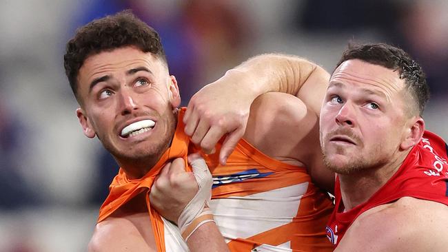 MELBOURNE, JULY 27, 2024: 2024 AFL Football - Round 20 - Melbourne Demons V GWS Giants at the MCG. Steven May of the Demons under pressure from Jake Riccardi of the Giants. Picture: Mark Stewart