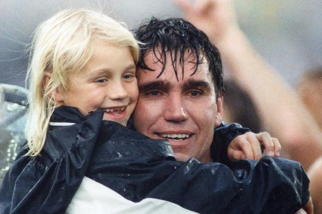 Footballer Greg Phillips with tears in his eyes hugging daughter Erin Phillips after SANFL Glenelg vs Port Adelaide grand final match at Football Park in 1992. Picture: Neon Martin