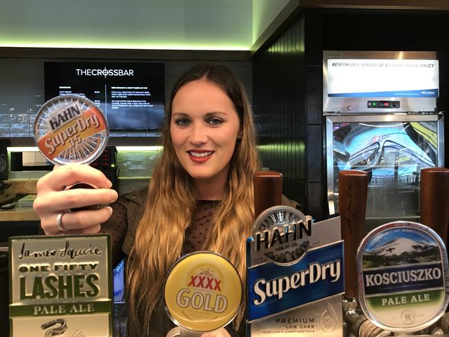 Elis De Souza changes the beer taps at ANZ Stadium. Picture: Julian Keith
