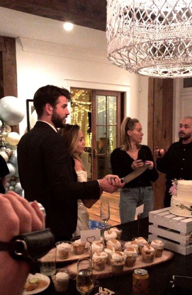 The rumour mill is in overdrive after pictures emerged of what appeared to be Miley Cyrus and Liam Hemsworth cutting a wedding cake. Picture: Instagram/Conrad Carr