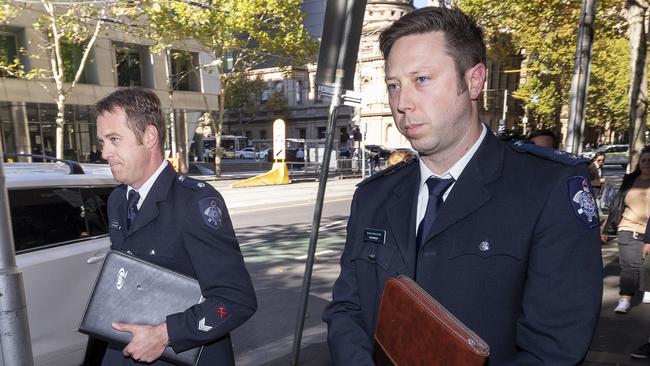 Firefighter Brett Wilson (left) and senior station officer Tim Erikson leave the Melbourne Magistrates’ Court. Picture: AAP