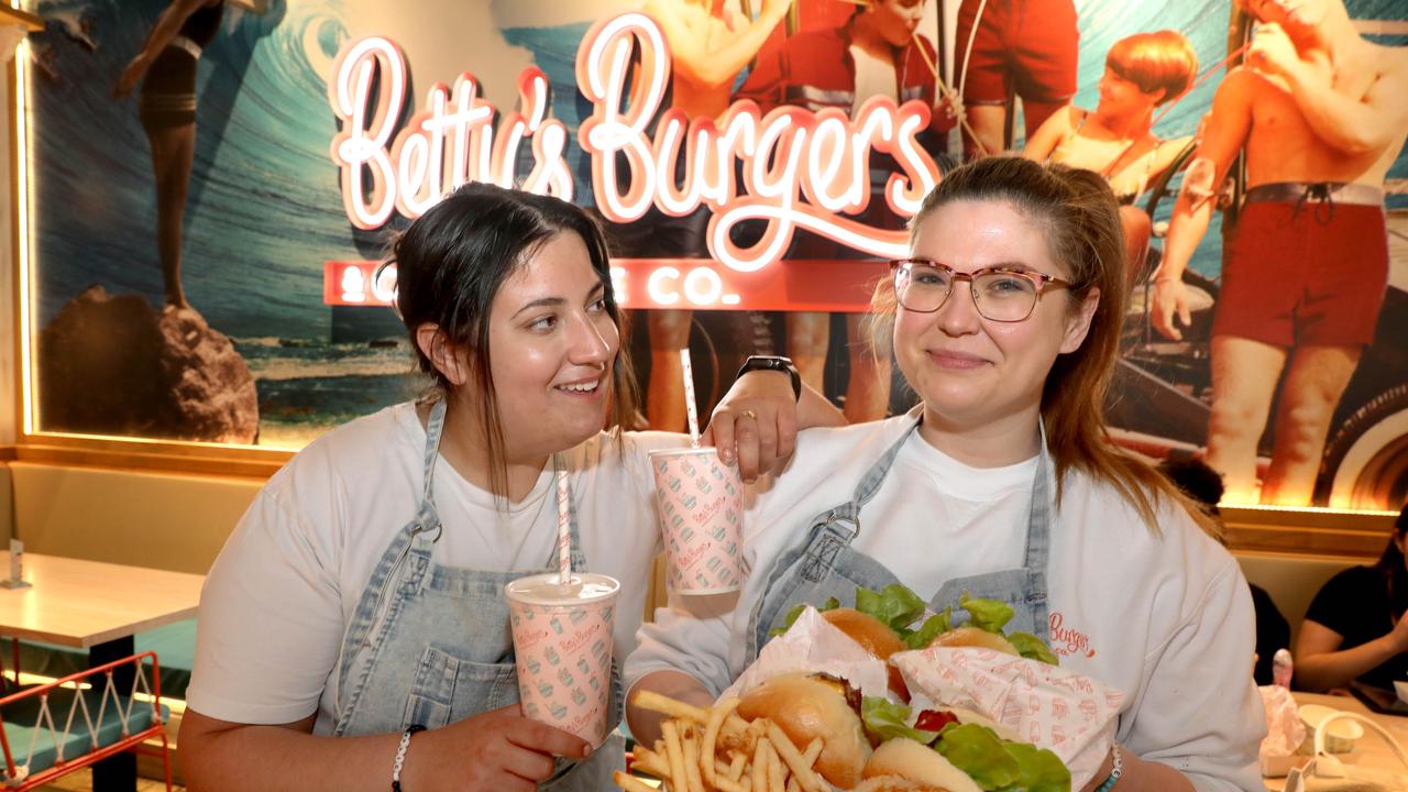 Bec Richards and Melinda Porcaro at the new Adelaide Betty’s Burgers store this week. The Retail Zoo owned chain has exploded in popularity and profitability. Picture: NCA NewsWire / Dean Martin