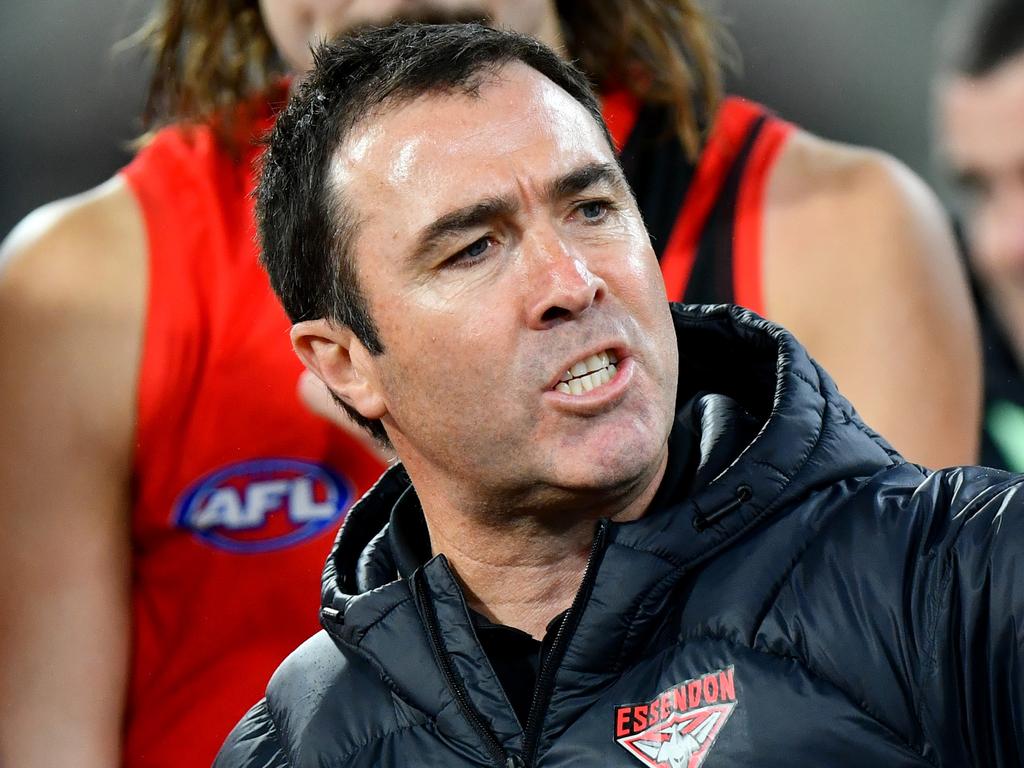 MELBOURNE, AUSTRALIA – JULY 13: Brad Scott, Senior Coach of the Bombers speaks to his players during the round 18 AFL match between Melbourne Demons and Essendon Bombers at Melbourne Cricket Ground, on July 13, 2024, in Melbourne, Australia. (Photo by Josh Chadwick/AFL Photos/via Getty Images)