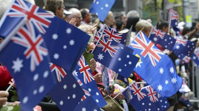 People wave flags as an ANZAC Day parade marches by in Sydney, Australia, Saturday, April 25, 2015. The ANZAC Day memorial Saturday marks the 100th anniversary of the 1915 Gallipoli landings, the first major military action fought by the Australian and New Zealand Army Corps during World War I. (AP Photo/Rob Griffith). Picture: Rob Griffith