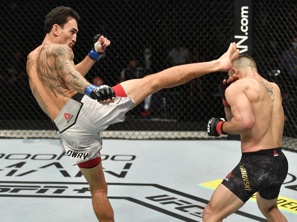 Max Holloway kicks Alexander Volkanovski. (Photo by Jeff Bottari/Zuffa LLC)