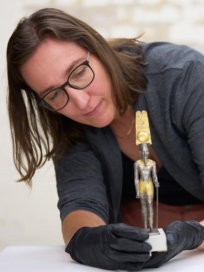 British Museum curator Dr Marie Vandenbeusch examining a statue of Amun-Ra that will be showcased at the NGV in 2024. Picture: Josh Caius