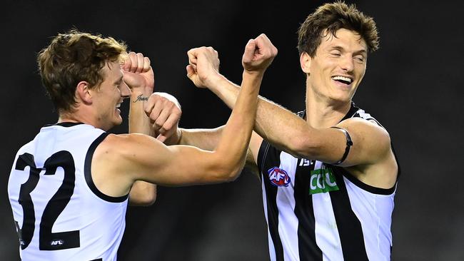 Brody Mihocek (right) is waiting to sign a new contract with Collingwood.