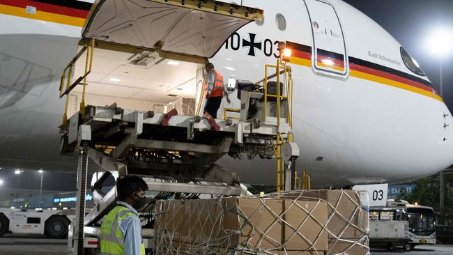 Ground staff unload coronavirus medical aid supplies from Germany, at an airport in New Delhi. Picture; AFP.