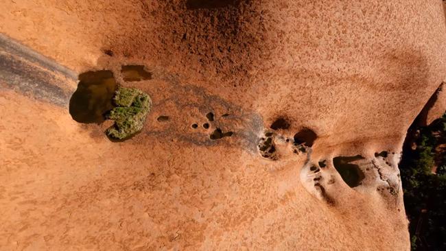 These waterholes are just some of the incredible features on Uluru revealed in the footage. Picture: Voyage indigenous Tourism Australia