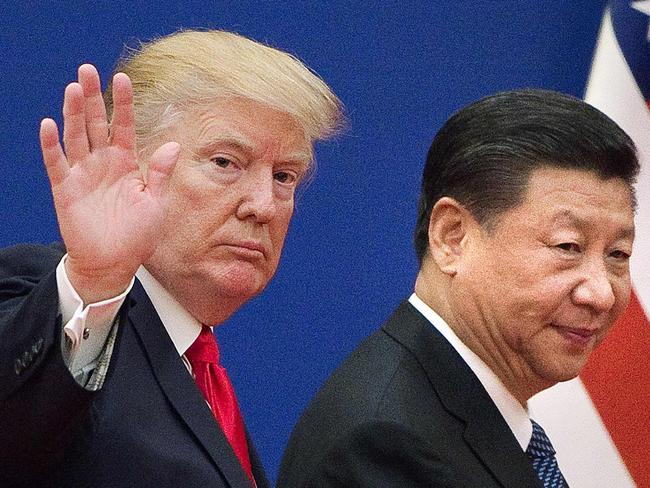 (FILES) This file photo taken on November 08, 2017 shows US President Donald Trump (L) and China's President Xi Jinping leaving a business leaders event at the Great Hall of the People in Beijing. - The new partial trade agreement between the United States and China will be signed in the middle of next month in Washington, US President Donald Trump said on December 31, 2019. 