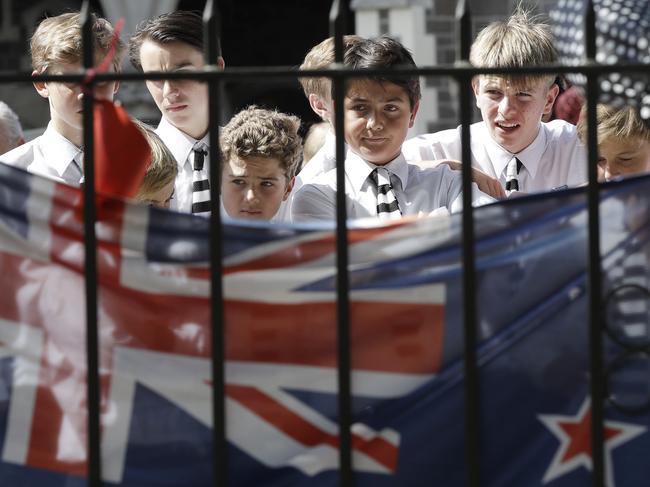 Students embrace at a floral tribute at the Botanical Gardens in Christchurch, New Zealand. Picture: AP