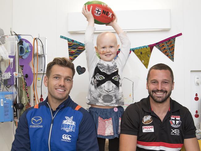 North Melbourne Player Shaun Higgins and Saints captain Jarryn Geary with Sierra Colwell. Picture: Jason Edwards