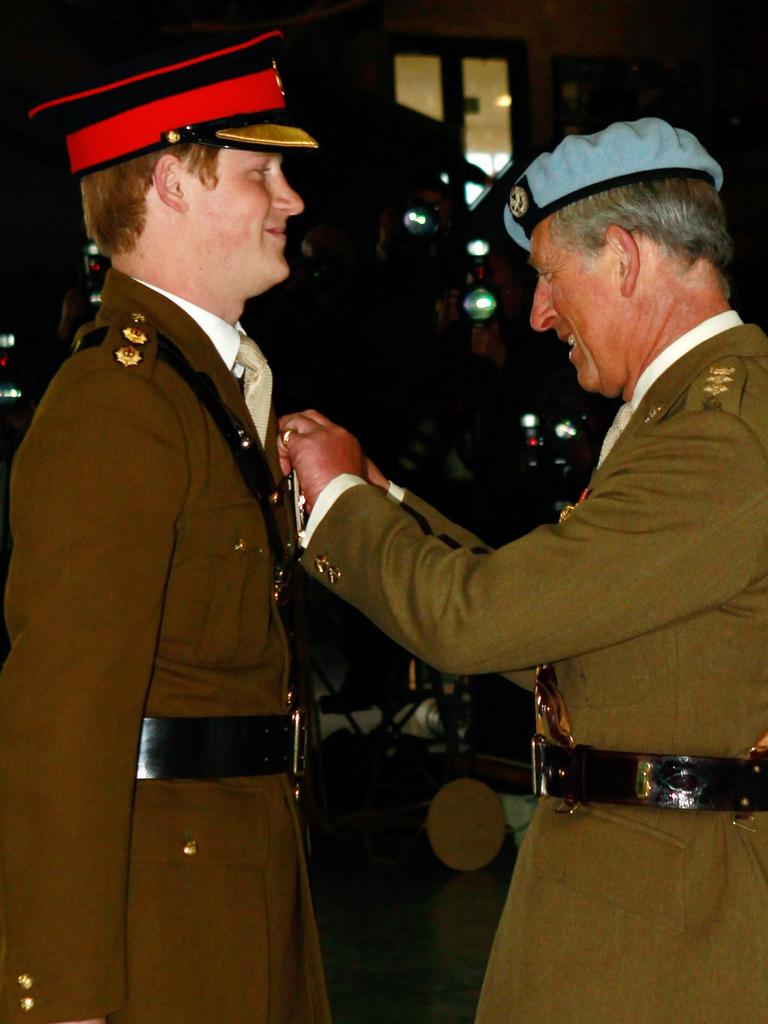 Then Prince Charles presents Prince Harry with his flying badges in 2010. Now the King, he has taken one of his son’s highest military honours. Picture: Getty Images