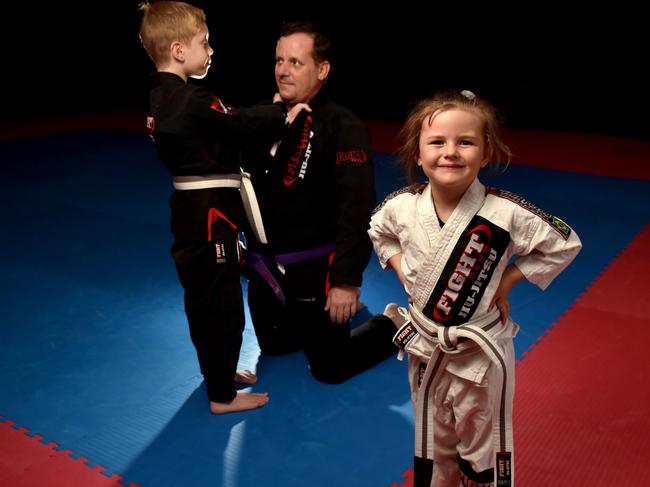 Fight Club Townsville instructor Eric Lemoine with Quade Powers, 8, and Isabelle MacLean, 6. Picture: Evan Morgan