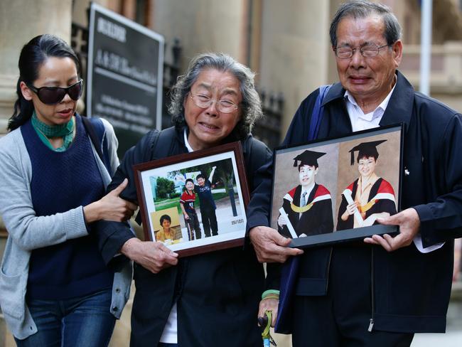 From left: Kathy Lin with her parents Yang Fei Lin and Feng Qing Zhu, who are holding pictures of their slain relatives. Picture: Cameron Richardson