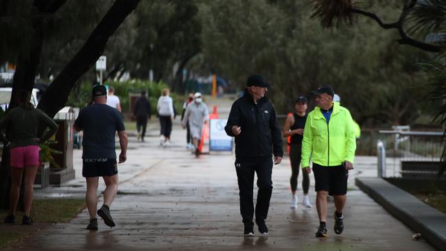 Surfers Paradise wakes up to its first day in lockdown due to the latest CoVid-19 scare. Tradesman still at work at Paradise Centre.Some consider walking a strenuous excercise and dont wear masks... Picture Glenn Hampson