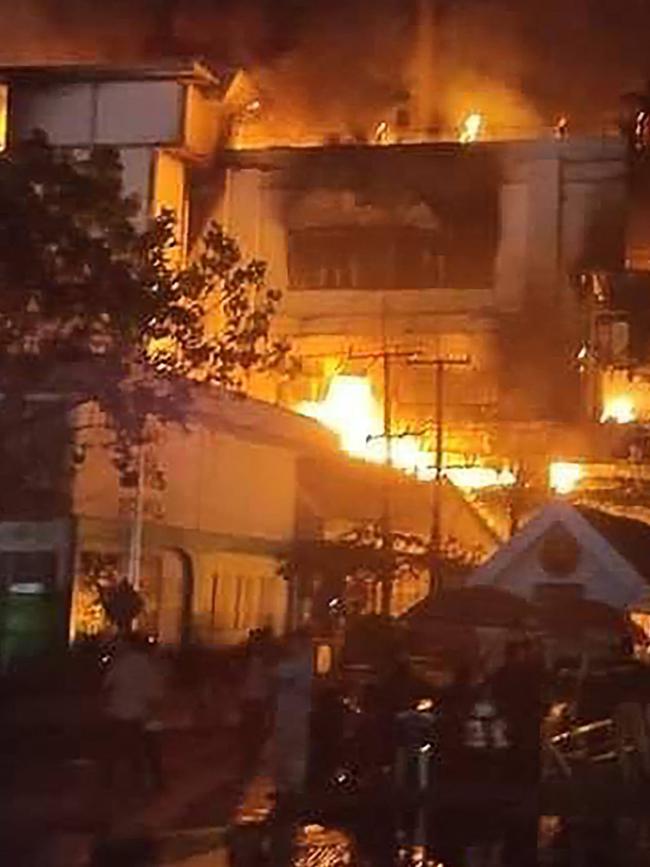 Firefighters and rescue workers gather at the site of a fire at the Grand Diamond City hotel-casino. Picture:AFP.