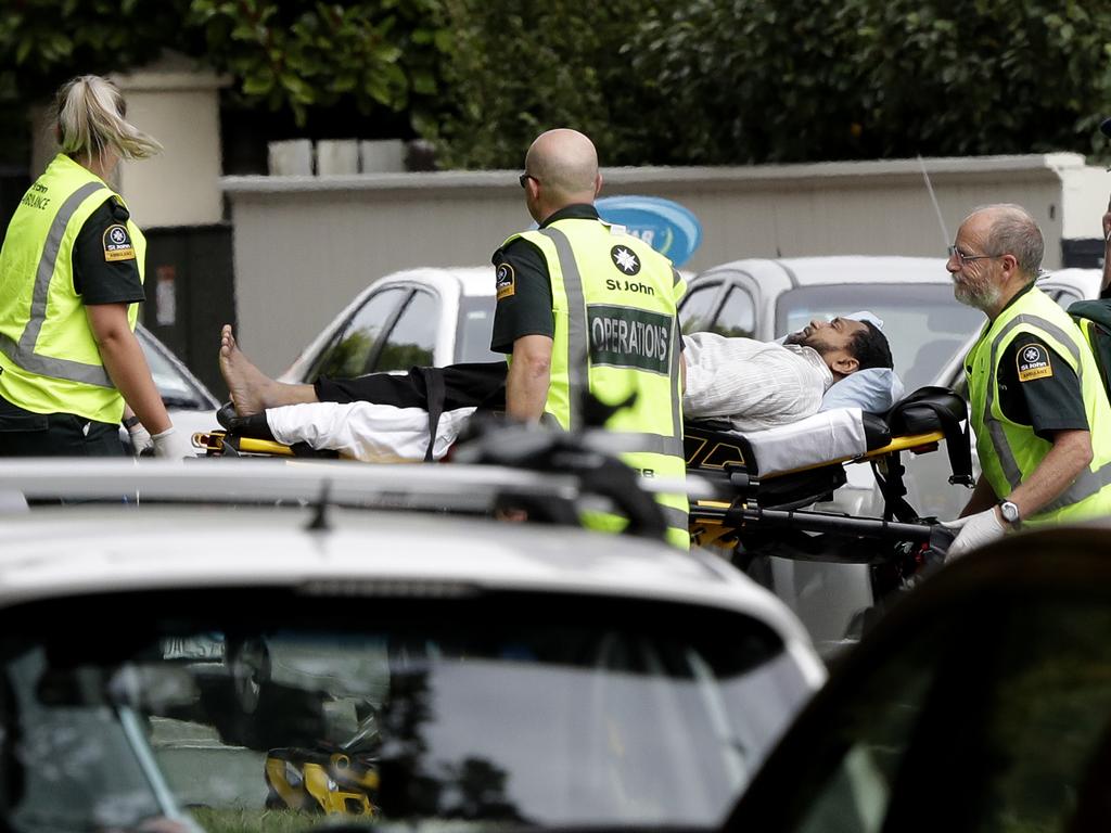 Ambulance staff take a man to hospital. Picture: Mark Baker