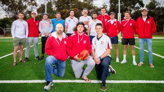 Fish Creek Football Club president Jason Harding, captain Brent Cooper and coach Greg Hoskin in front of other players and officials. Picture: Mark Stewart