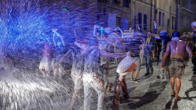 Israeli police fire water cannons to disperse anti-government protesters in Jerusalem on Saturday. Picture: AFP