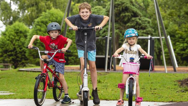 In Toowoomba's Queens Park are (from left) Harley, Jayce and Victoria McLeod on their Christmas presents on a day of unpredictable weather, Friday, January 7, 2022. Picture: Kevin Farmer