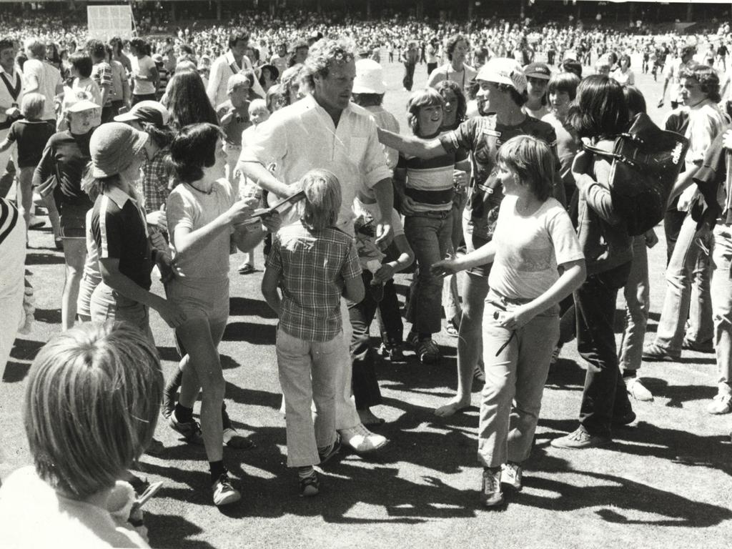 Fast bowler Rodney Hogg is surrounded by fans as he leaves the field.