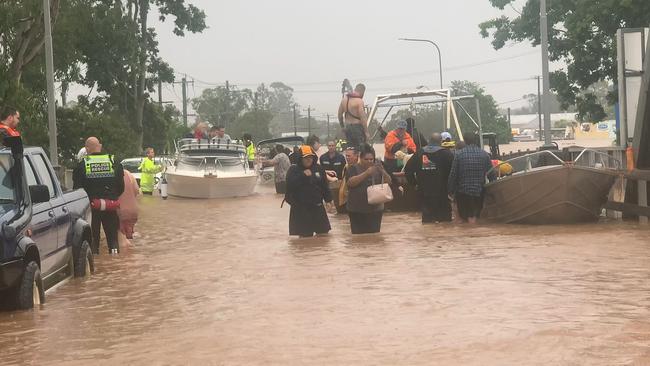 Rescue crews drop people off at the Ballina Street Bridge in South Lismore on February 28, 2022.